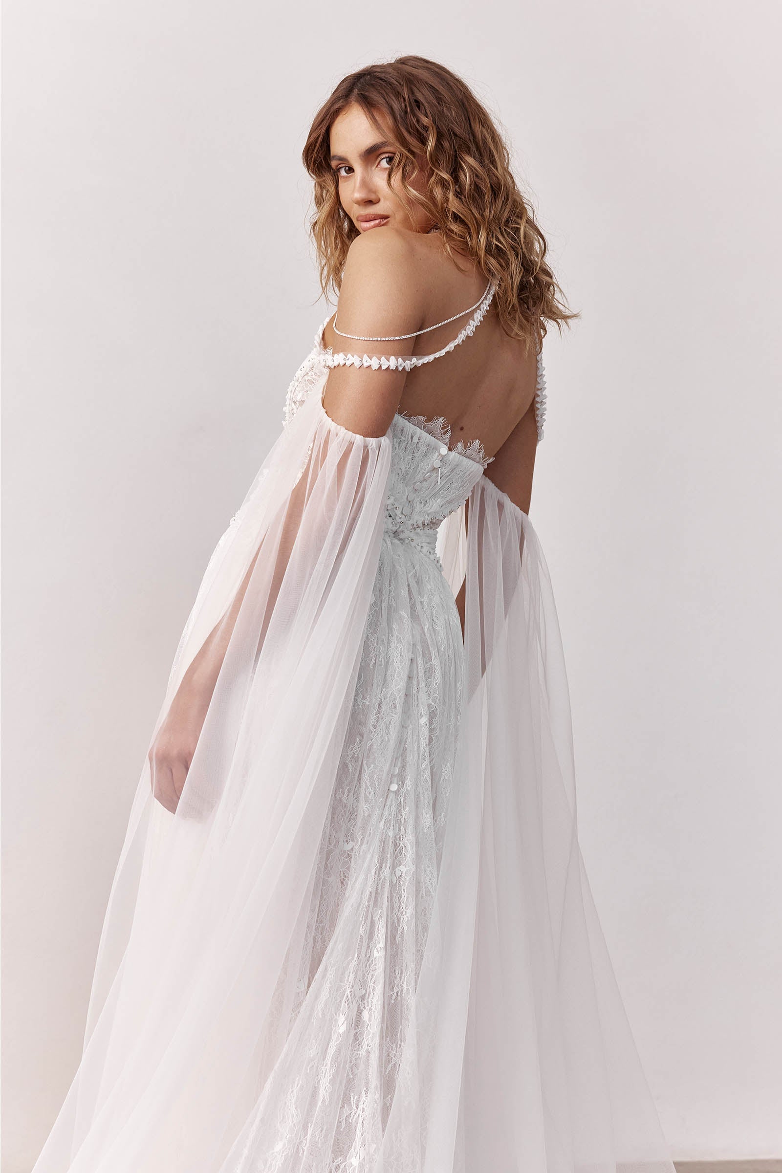 Woman wearing a lace wedding dress with sheer sleeves_XS_