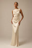 A woman modeling a sleeveless, off-the-shoulder floor-length gown in a warm ivory or cream satin fabric against a solid beige studio background_XS_