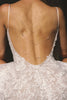 woman wearing a white lace backless dress with thin straps and delicate chain jewellery across her back_XS_