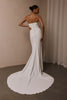 A woman wearing a strapless white mermaid style gown_XS_