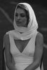 Woman wearing a white shawl and wedding dress