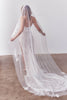 Bride wearing a wedding dress and long veil with floral details_XS_