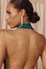 Close up detailing of bridal earrings and halter neck dress
