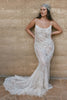 Woman wearing a lace wedding dress and headscarf.