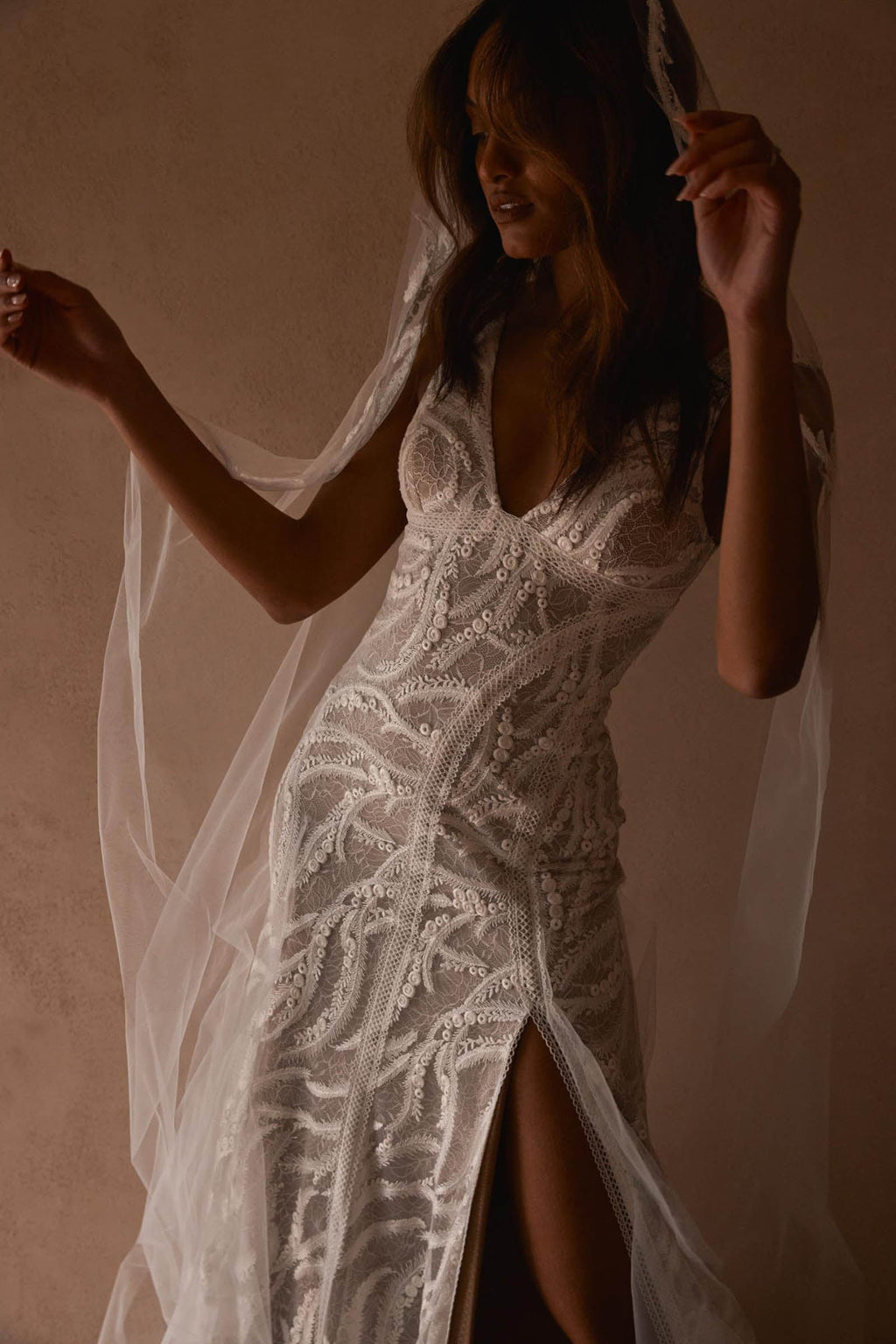 Model dancing in Solstice gown and veil