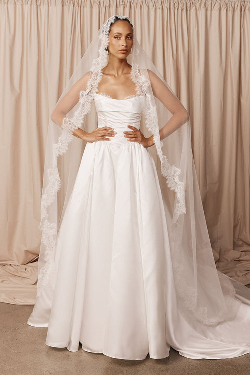 Bride wearing a lace mantilla veil and wedding dress