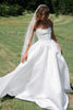 Woman wearing a satin A-line wedding dress_XS_