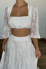 A woman wearing a two-piece wedding dress.